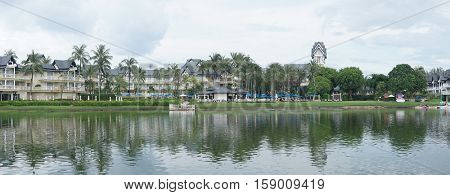 Lovely view of the lake near luxurious tropical resort over cloudy sky during day