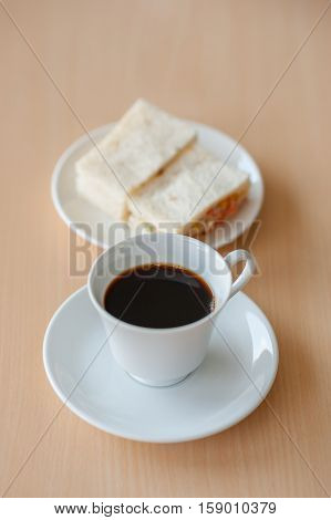cup hot coffee on table  with sandwich tuna