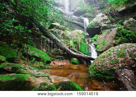 Saithip waterfall in Phu Soi Dao National Park Thailand. A small waterfal with beautiful scenery of lush rocks and forest line