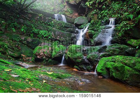 Saithip waterfall in Phu Soi Dao National Park Thailand. A small waterfal with beautiful scenery of lush rocks and forest line