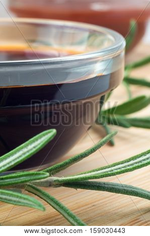 Soy Sauce In A Glass And A Sprig Of Rosemary