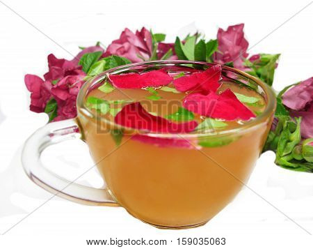 rose tea punch cocktail in jug and cup with cinnamon