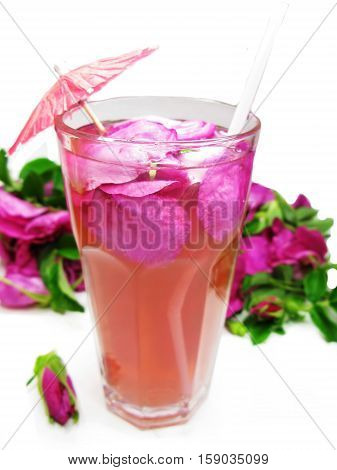 rose tea punch cocktail in jug and cup with cinnamon
