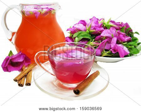 rose punch tea cocktail punch in jug and cup and cinnamon