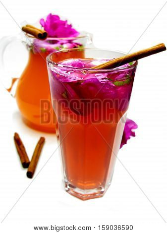rose tea punch cocktail in jug and cup with cinnamon