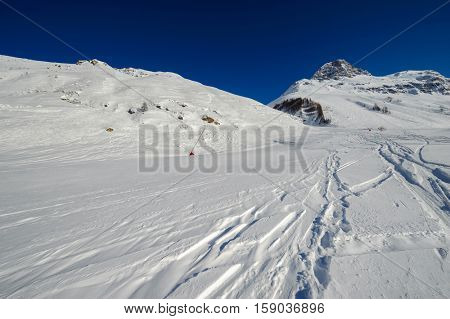 Alpine winter mountain landscape. French Alps covered with snow in sunny day. Val-d'Isere, France