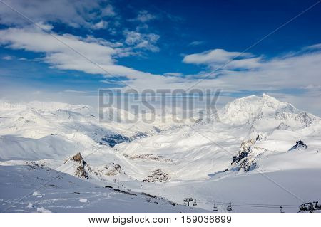 Alpine winter mountain landscape. French Alps covered with snow in sunny day. Val-d'Isere, France