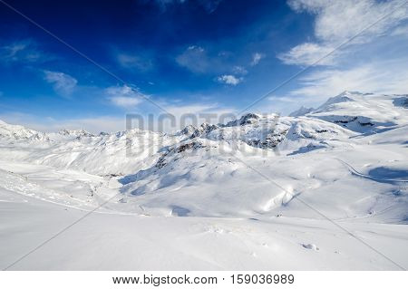 Alpine winter mountain landscape. French Alps covered with snow in sunny day. Val-d'Isere, France