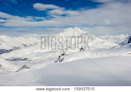 Alpine winter mountain landscape. French Alps covered with snow in sunny day. Val-d'Isere, France