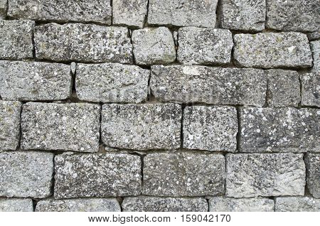 Old stone wall closeup in sunny day