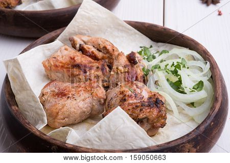 Grilled lamb meat with marinated onion in rustic style