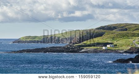 Ellistion cliffs, Newfoundland, hillsides and shoreline.   Rocky coastline in Elliston village along the coast fingers of the Island of Newfoundland, Canada.