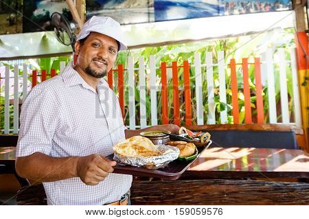 Indian chef serving food on Sony a6300 29, 9 fps HD