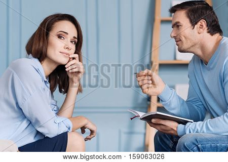 I feel better now. Professioanl handsome psychotherapist sitting in the arm chair and talking with his patient
