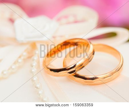 Two Golden Wedding Rings with purls on pillow