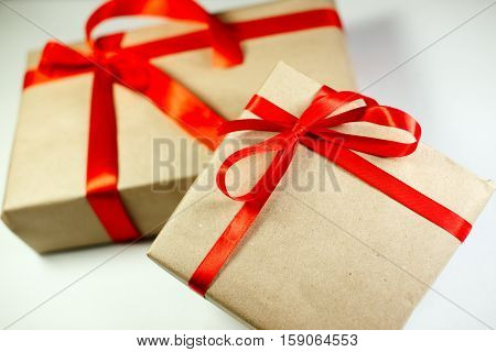 Classy Christmas gifts box presents on white background. Small Handmade gift boxes with red ribbons