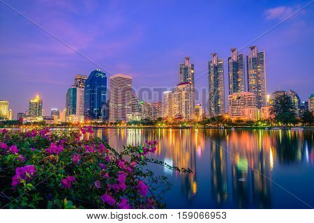Cityscape image of Benchakitti Park at night sky in Bangkok Thailand.