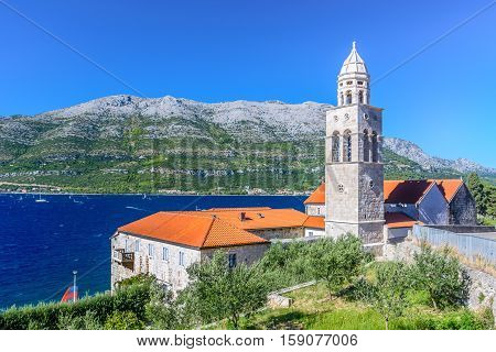 View at mediterranean landscape with Dominican Monastery in town Korcula with surfing place Viganj in background, Croatia summertime, Europe.