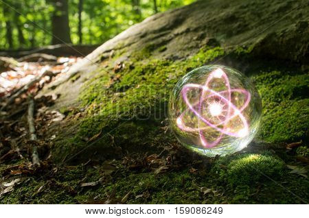 Magic crystal ball atom on forest floor for summer fantasy imagery
