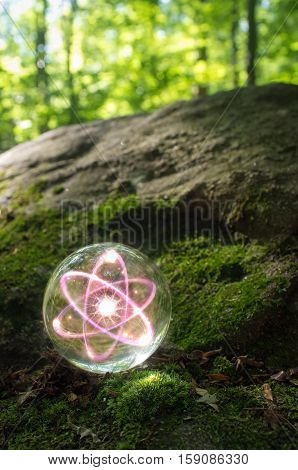Magic crystal ball atom on forest floor for summer fantasy imagery