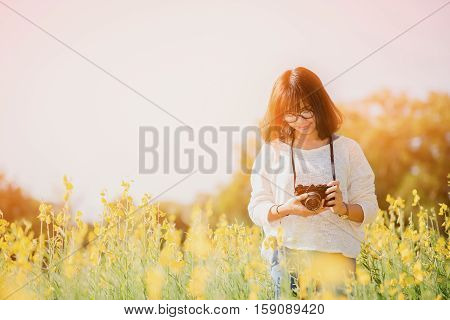 Young Woman With Camera In The Sunhemp Garden