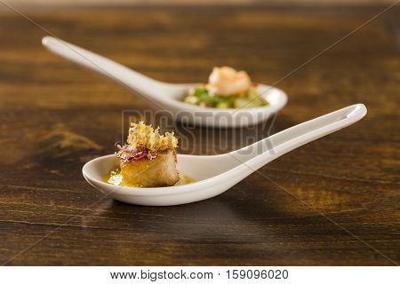 Grilled Fish With Reduction Of Yellow Fruits And Aligot Baiano In A Spoon. Taste Gastronomy Finger F