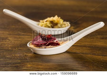Thousand Leaves Of Radish And Beet With Caramelized Bacon Julienne In A Spoon. Taste Gastronomy Fing
