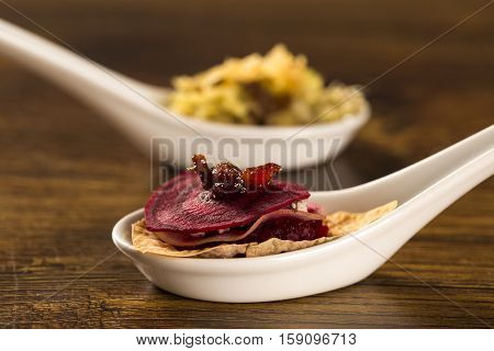 Thousand Leaves Of Radish And Beet With Caramelized Bacon Julienne In A Spoon. Taste Gastronomy Fing
