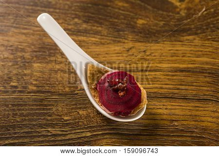 Thousand Leaves Of Radish And Beet With Caramelized Bacon Julienne In A Spoon. Taste Gastronomy Fing