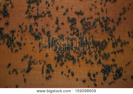 Green tea on a wooden surface. Crumbly tea