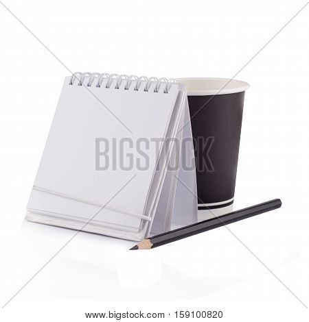 Front view of a white paper notebook with metallic spiral a black pen and a take away coffee black up isolated