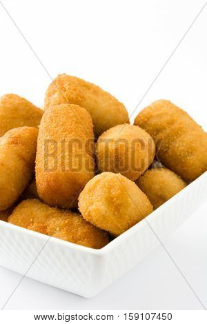 Traditional fried Spanish croquetas (croquettes) isolated on white background
