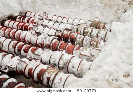 Bunker with rotating rolls for processing snow from city streets.