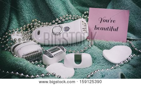 Epilatory With A Turquoise Background, Words On Pink Paper