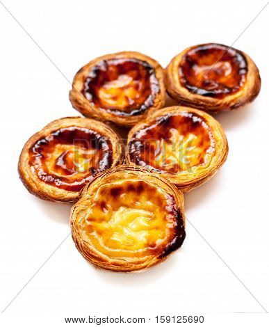 Egg Tarts isolated on white background. Heap of Typical portuguese dessert pasteis de nata close up