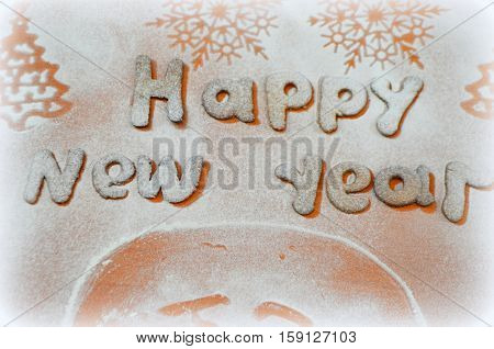 happy new year with a biscuit with icing sugar