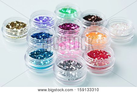 glitter for nail decoration on the white bacground