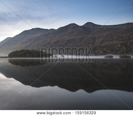 Beautiful Autumn Fall Landscape Image Of Crummock Water At Sunrise In Lake District England