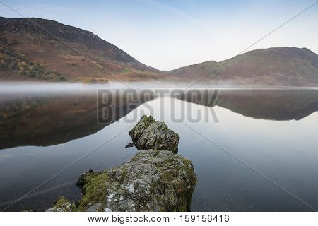 Beautiful Autumn Fall Landscape Image Of Crummock Water At Sunrise In Lake District England