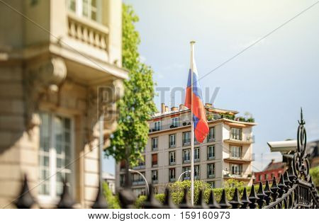 Waving Russian Federation flag waving in front of Consulate of Russia in Strasbourg France. Tilt shift lens used to accent the flag for more natural effect