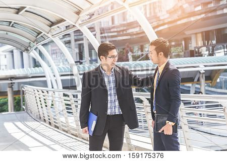 Two Businessman Dicussing Business In Central Of City. Concept Of Modern Business