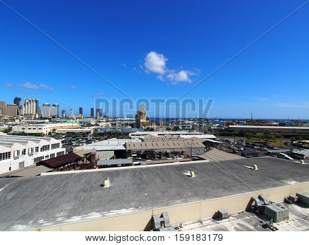 Aerial view of the Honolulu Port and downtown skyline with landmarks Aloha Tower Nimitz Highway and modern skyscrapers on Oahu Hawaii.