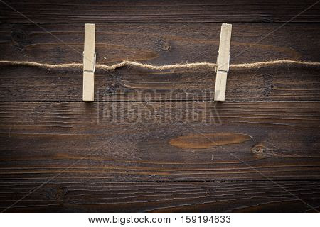 Wood Cloth Peg And Hemp Rope On Brown Plank Background
