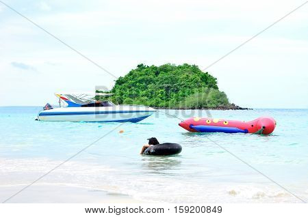 speed boat and banana boat floating in the sea.