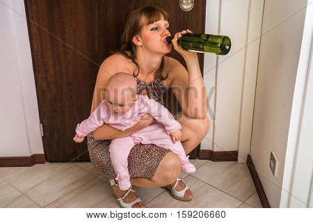 Drunk Reckless Woman Drinking Alcohol And Holding Her Baby