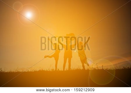 Silhouette of people playing guitar at the sky sunset happy time in holiday vintage tone
