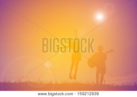Silhouette of people playing guitar at the sky sunset happy time in holiday vintage tone
