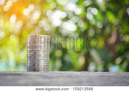 coin on wood tree bokeh background.selective focusconcept save money for my home