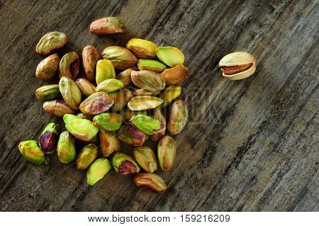 Close-up image of pistachios on wooden background