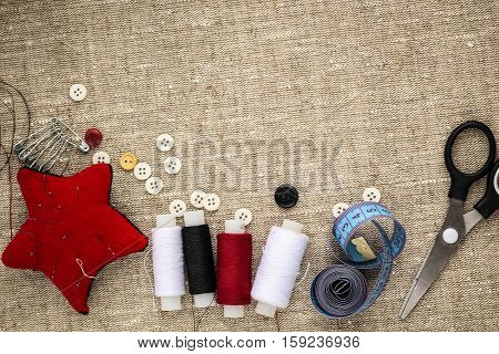 pin cushion with needlesthread and buttons for sewing